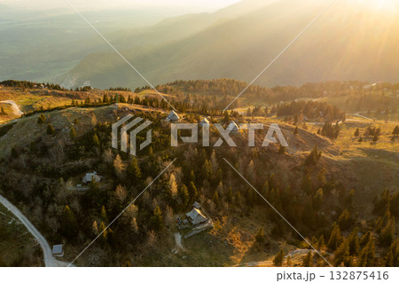Mountain village in Alps, wooden houses at sunset, Velika Planina, Kamnik, Slovenia Mountain village in Alps, wooden houses at sunset, Velika Planina, Kamnik, Slovenia 132875416