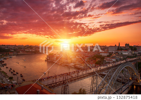 Scenic view of Porto city during sunset with a bridge over the river in Portugal. Scenic view of Porto city during sunset with a bridge over the river in Portugal. 132875418