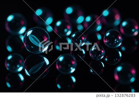 Neon Glass Marbles On Glossy Black Surface With Cyan And Magenta Highlights 132876283