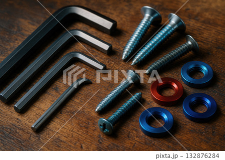Allen Keys, Screws, And Anodized Washers On Wooden Workbench 132876284