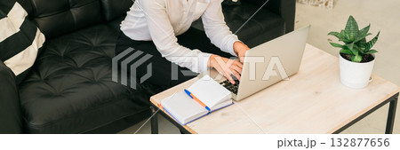 Banner Businesswoman working remotely with laptop at home. Freelance, productivity and digital lifestyle concept. Copy space 132877656