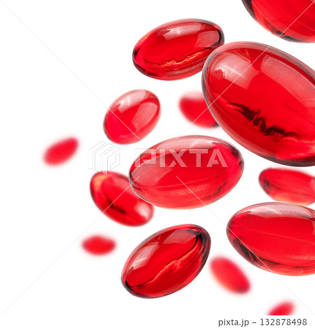 Red capsules levitate on a white background 132878498