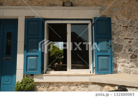 Blue Shutters Greek Stone House Window Blue Shutters Greek Stone House Window 132880065