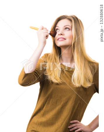 Smiling woman holding make up brush 132880618