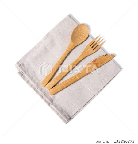 Top View Bamboo Cutlery Set On Beige Linen Napkin Isolated Top View Bamboo Cutlery Set On Beige Linen Napkin Isolated 132880873