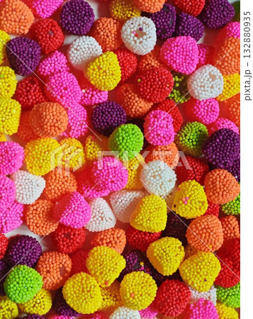 Vertical. Sweet candy. Colorful candies in a white plate Vertical. Sweet candy. Colorful candies in a white plate 132880935
