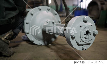 Factory worker assembling metal industrial part mechanism 132881585