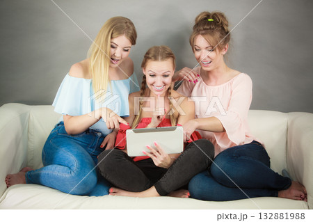 Three women using tablet Three women using tablet 132881988