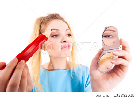 Woman painting eyebrows using regular pencil 132882019