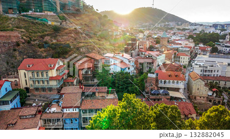 vIEW ON OLD TOWN OF tBILISI IN SUNSET. cABLE CAR IN AIR AND tv TOWER IN DISTANCE 132882045