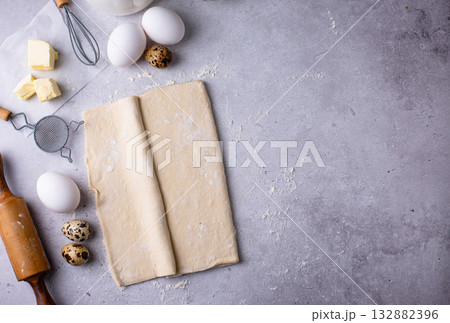 Raw puff pastry dough with baking ingredient Raw puff pastry dough with baking ingredient 132882396