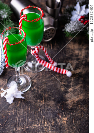 Christmas green cocktail punch with candy cane Christmas green cocktail punch with candy cane 132882404