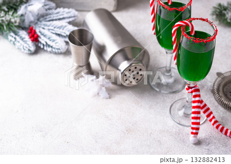 Christmas green cocktail punch with candy cane Christmas green cocktail punch with candy cane 132882413