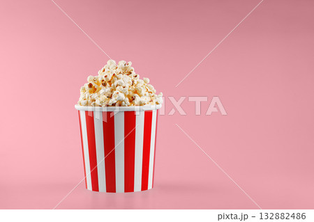Classic red striped popcorn cardboard cup on Red background 132882486