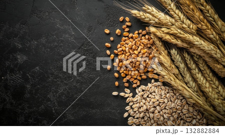 Wheat grains and barley on black stone background 132882884