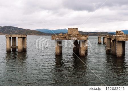 Abandoned concrete pillars standing in reservoir panorama 132882943