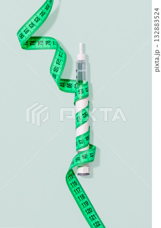 GLP-1 Weight Loss Injection Pen With Measuring Tape On Pastel Blue Background For Anti-Obesity Treatments, Diabetes Medical Visuals, Hormonal Therapy Concepts And Slimming Product Advertising GLP-1 Weight Loss Injection Pen With Measuring Tape On Pastel Blue Background For Anti-Obesity Treatments, Diabetes Medical Visuals, Hormonal Therapy Concepts And Slimming Product Advertising 132883524