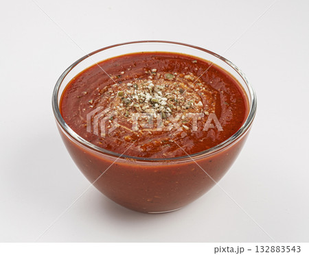 Glass bowl of tomato cream soup on white background 132883543