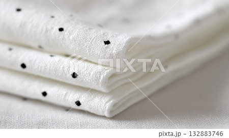 Crisp white background with folded polka dot cotton fabric, detailed textile texture for sewing, pattern design, and apparel branding use Crisp white background with folded polka dot cotton fabric, detailed textile texture for sewing, pattern design, and apparel branding use 132883746