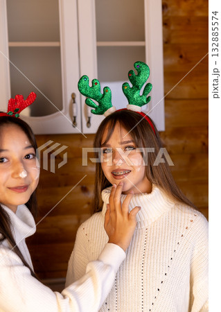 Two friends are getting ready for a Christmas celebration 132885574