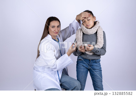 A doctor is checking the temperature of a sick child A doctor is checking the temperature of a sick child 132885582
