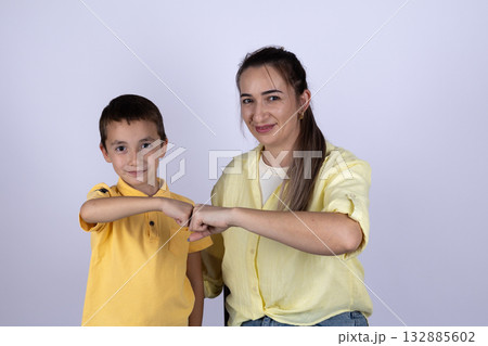 A woman and a boy are doing a fist bump A woman and a boy are doing a fist bump 132885602