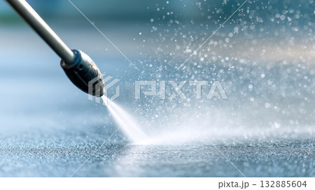 Pressure washer spraying water on surface outdoors Pressure washer spraying water on surface outdoors 132885604