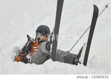 Skiing in the winter woman fallen over 132885819