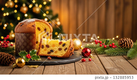 Festive panettone bread with chocolate chips on a wooden table, surrounded by holiday decorations and a warm, inviting atmosphere for celebration 132885953