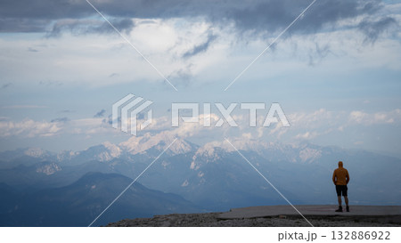Man enjoying the view on beautiful alpine landscape with mountains and ridges during sunset,Slovenia 132886922