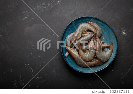 Fresh raw shrimps prawns plate dark background seafood uncooked copy space Fresh raw shrimps prawns plate dark background seafood uncooked copy space 132887131