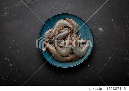Fresh raw shrimps prawns plate dark background seafood uncooked healthy 132887146