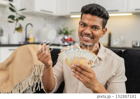 Indian man counts euro cash happy makes money gesture plans dream purchase savings bonus invest plan Indian man counts euro cash happy makes money gesture plans dream purchase savings bonus invest plan 132887181
