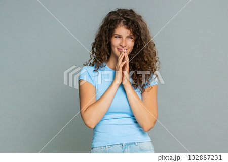 Young woman slyly rubbing hands scheming cunning sneaky mischievous playful secretive gesture mood 132887231