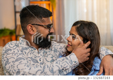Indian family couple man woman touching face and looking at each other with love and tenderness Indian family couple man woman touching face and looking at each other with love and tenderness 132887283