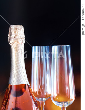 Bottle of champagne and two champagne glasses on dark background for New Year's celebration 132888267