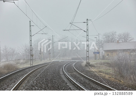 Double track railway main line rails in winter frost snow and fog Double track railway main line rails in winter frost snow and fog 132888589