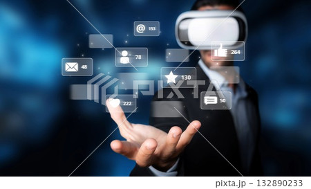 Businessman in Virtual Reality Glasses Engaging with Social Media Icons and Notifications, Representing Digital Communication and Innovation Trends. Raster Businessman in Virtual Reality Glasses Engaging with Social Media Icons and Notifications, Representing Digital Communication and Innovation Trends. Raster 132890233
