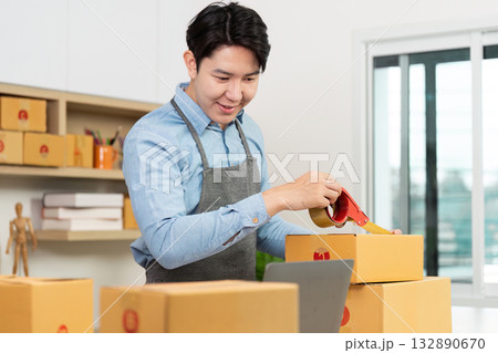 Entrepreneur sealing packages with tape in a modern workspace Entrepreneur sealing packages with tape in a modern workspace 132890670