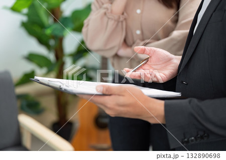 Real Estate Consultation. Professional agent discussing property details with client. 132890698