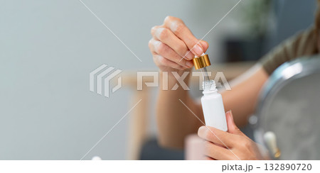 Skin Care Routine. Applying serum from a dropper bottle for healthy skin. Skin Care Routine. Applying serum from a dropper bottle for healthy skin. 132890720
