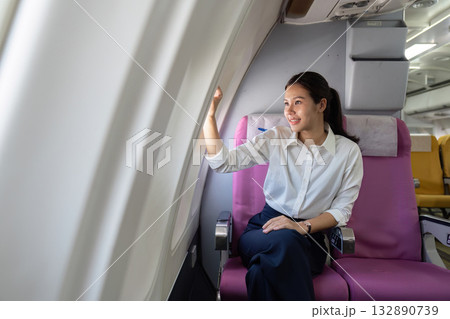 Travel Experience. Young woman enjoying window view on airplane. Travel Experience. Young woman enjoying window view on airplane. 132890739