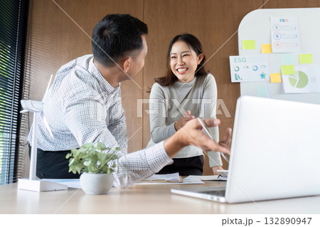 Sustainable Practices and ESG. Engaged professionals discussing green initiatives in a modern office. Sustainable Practices and ESG. Engaged professionals discussing green initiatives in a modern office. 132890947