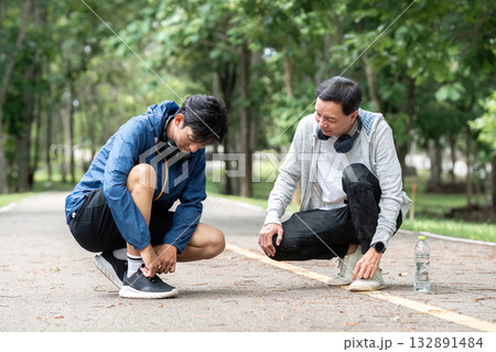 Father and Son Tying Shoelaces. Promoting wellness through supportive activities. 132891484