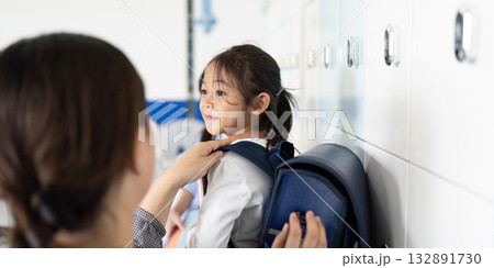 Back to School. Parent Helping Child with Backpack at School Locker Back to School. Parent Helping Child with Backpack at School Locker 132891730