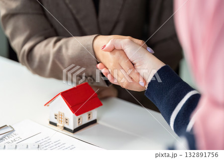 Real Estate Agreement. Two professionals shaking hands over a property deal. Real Estate Agreement. Two professionals shaking hands over a property deal. 132891756
