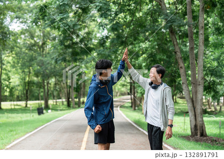 Father and Son Celebrating Wellness with High-Five Outdoors 132891791
