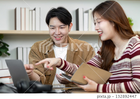Collaborative Study Session. Young students engaging in productive discussion over laptop. Collaborative Study Session. Young students engaging in productive discussion over laptop. 132892447