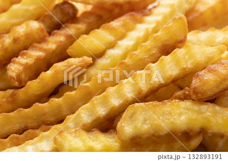 Heap Of Crinkle Cut French Fries. Close-up 132893191