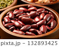 Raw red kidney beans in wooden bowl. Close-up 132893425